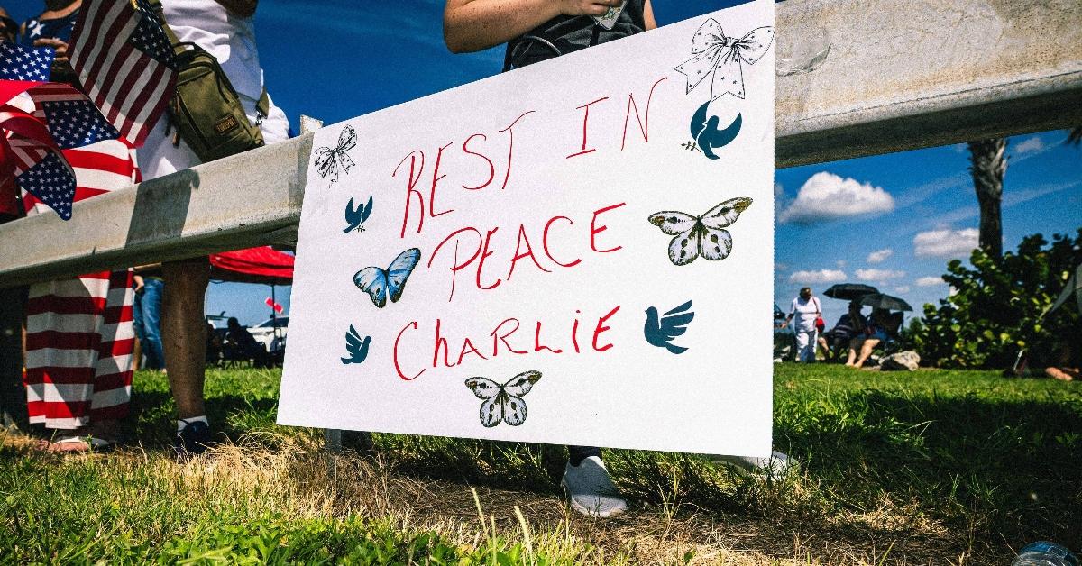 "Rest in Peace Charlie" sign hangs on a fence