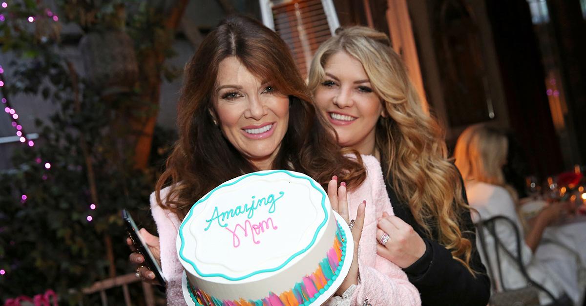 Lisa Vanderpump at Pump holding a cake. 