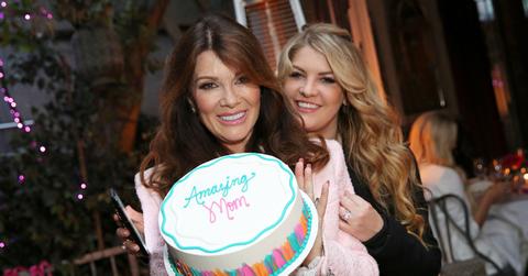 Lisa Vanderpump at Pump holding a cake.