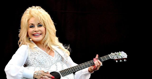 Dolly Parton performing onstage at a music festival in England on June 29, 2014.