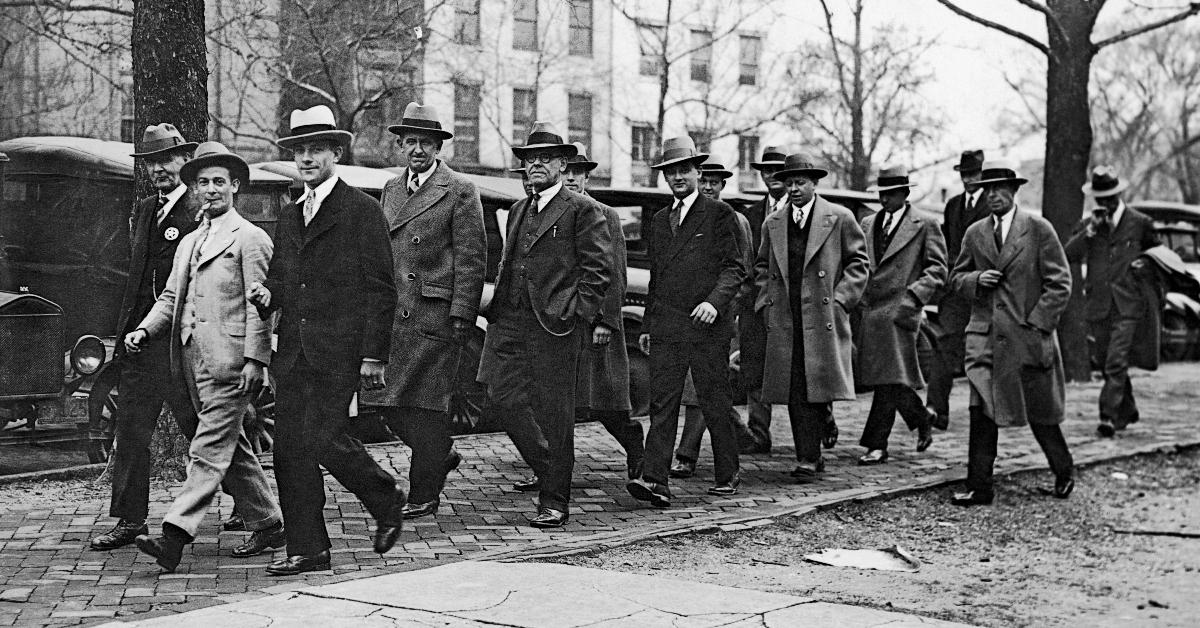 The jury members of the Teapot Dome Trial trying oilman Harry Sinclair for fraud are escorted by US Marshals on their way to lunch to avoid another mistrial, Washington DC, April 10, 1928