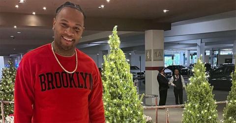 Oliver Saunders in a red sweatshirt with Christmas trees.