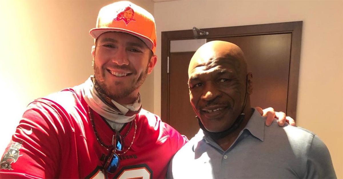 Pete Alonso and Mike Tyson in front of a door. 