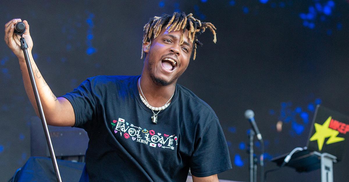 Juice Wrld performing in a t-shirt that says Evolve. 