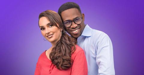 Rayne and Chidi pose close to each other against a purple background