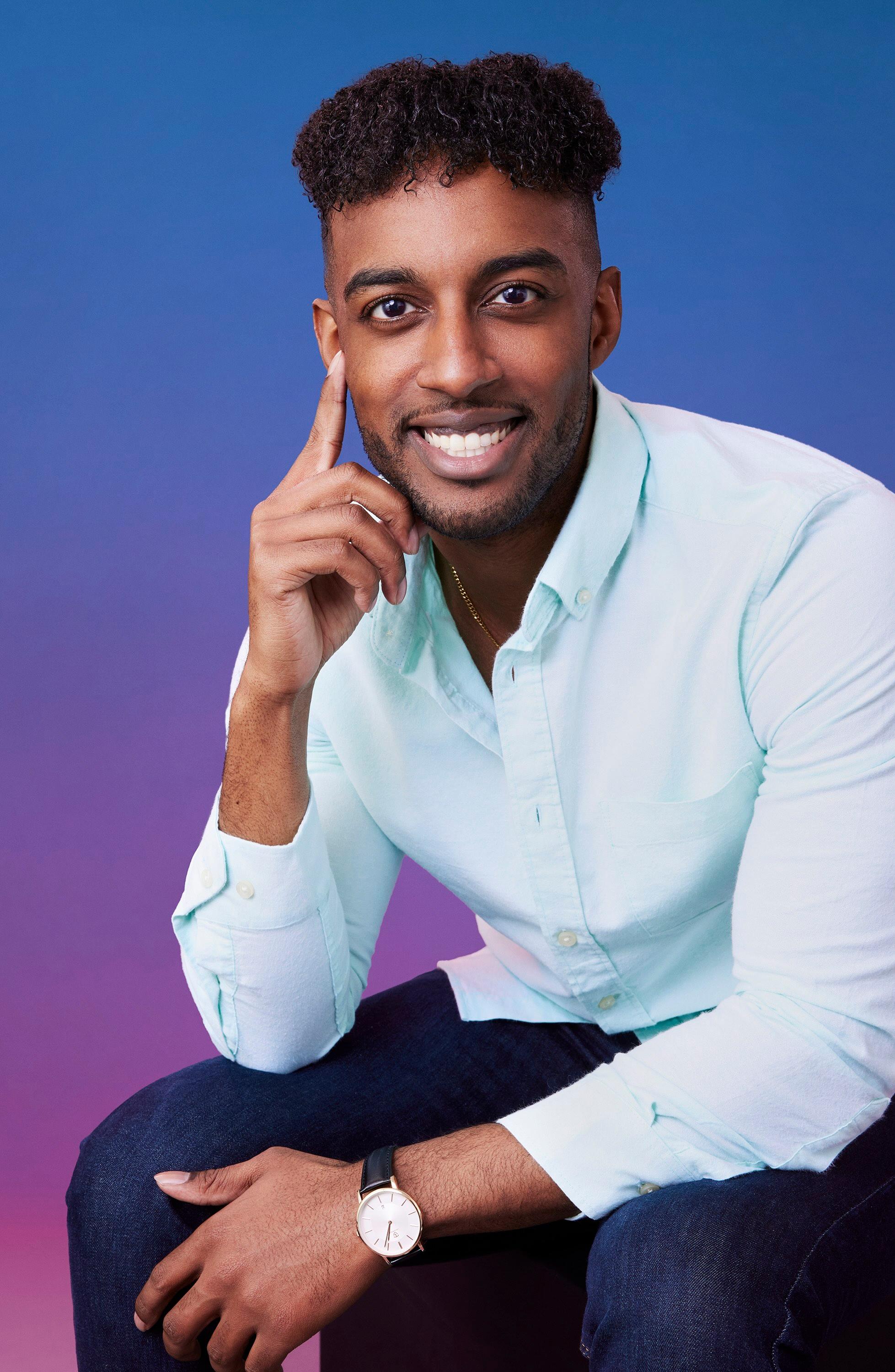 Hakeem poses in front of a blue-purple ombré background for his official 'The Bachelorette' Season 21 portrait.