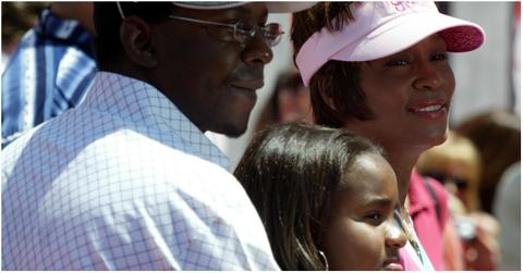 Bobby Brown, Bobbi Kristina Brown, and Whitney Houston at a premiere.