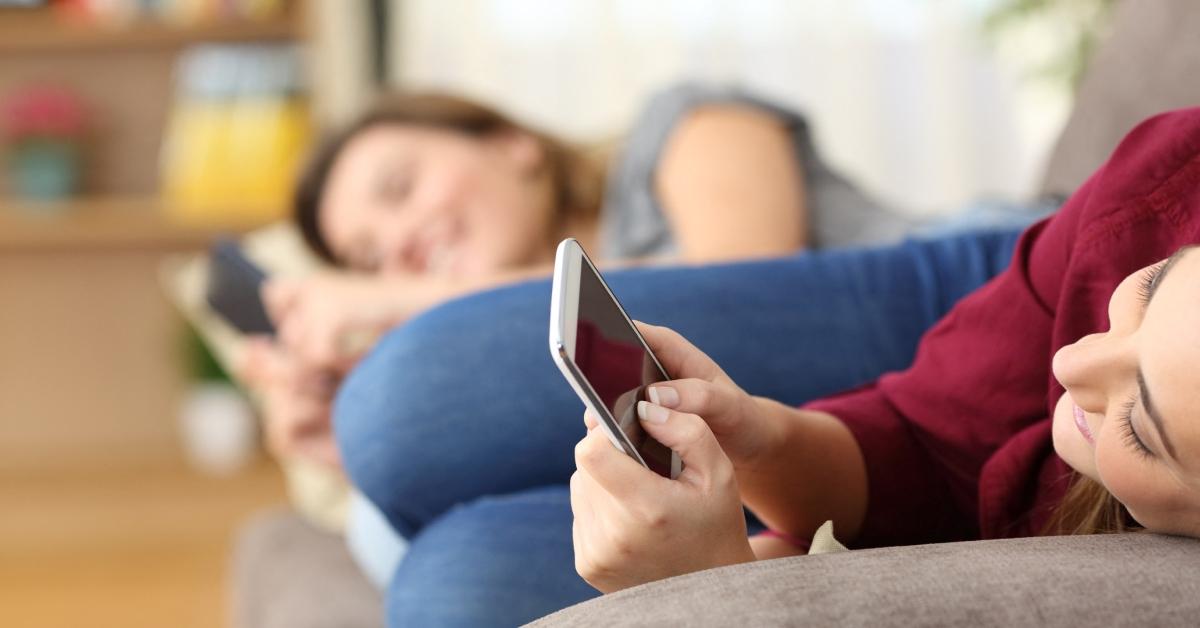 Two young women on their phones