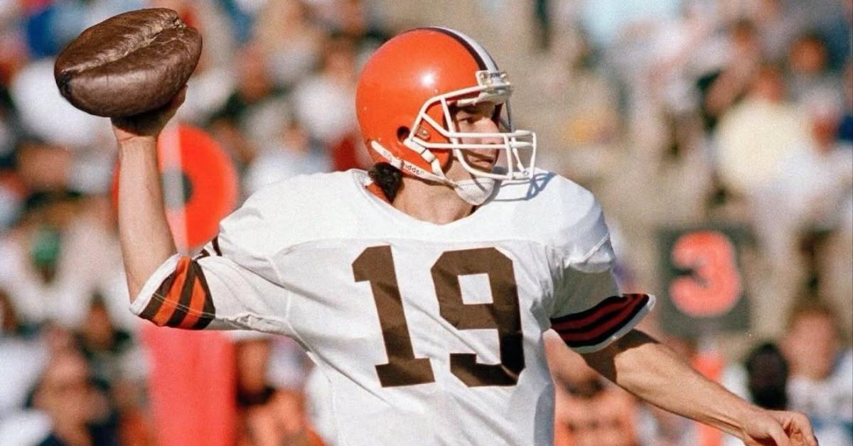 Bernie Kosar throwing a coffee bean-shaped football.