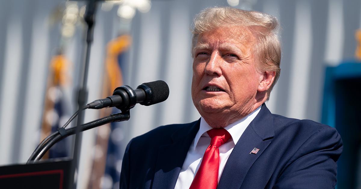 Donald Trump makes a face at a lectern. 