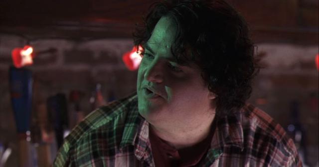 Steven Bailey wearing a flannel shirt as Joe the bartender