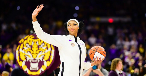 angel Reese waving in LSU tracksuit