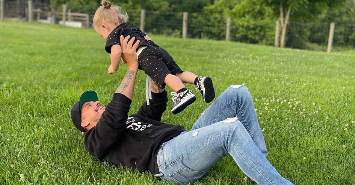 Jax Taylor with his son in the grass