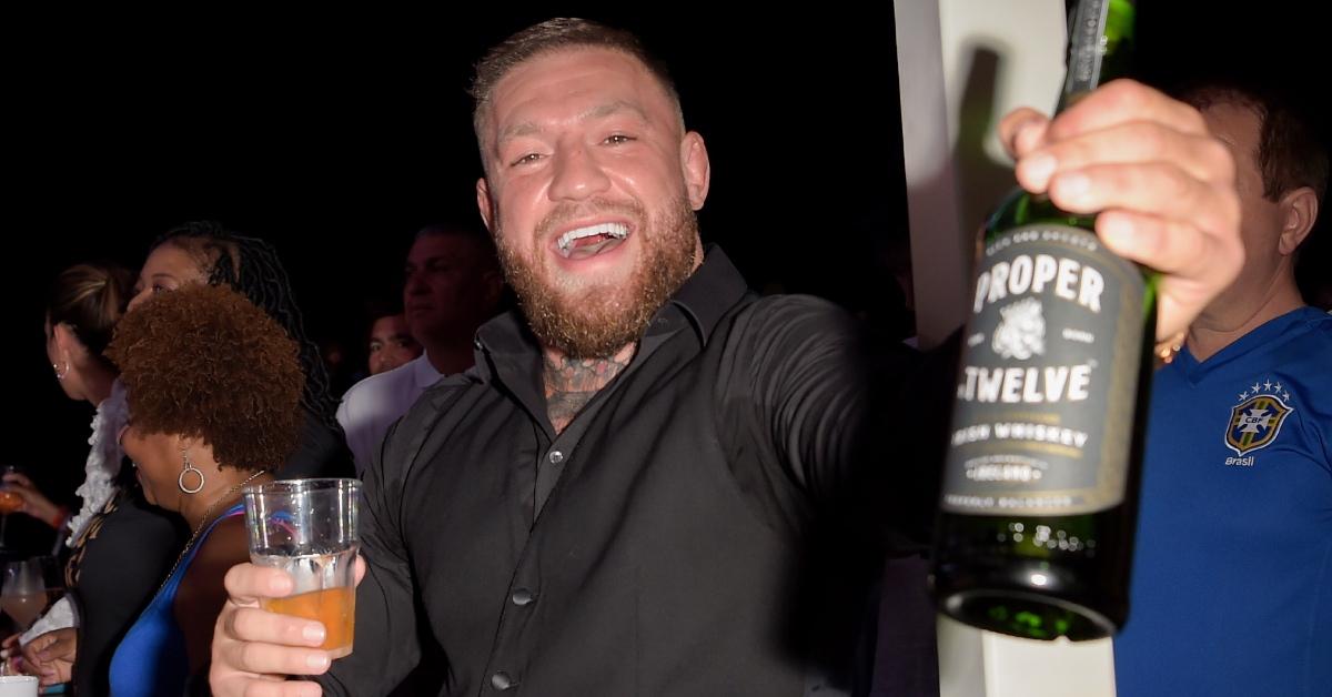 Conor McGregor holding a bottle of Proper No. Twelve.