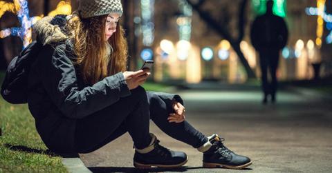 depressed woman sitting under street lamp picture id