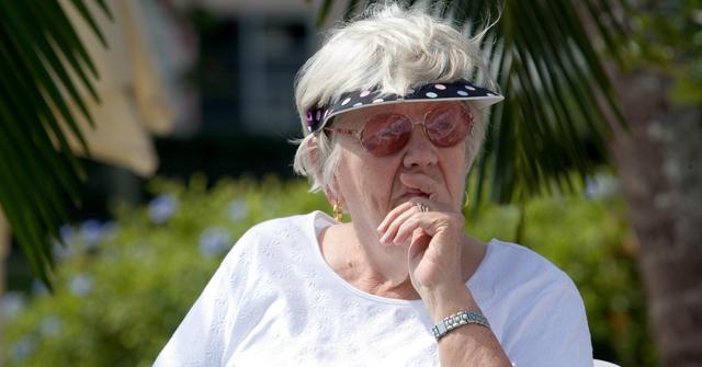 Woman sitting in chair at outdoor event