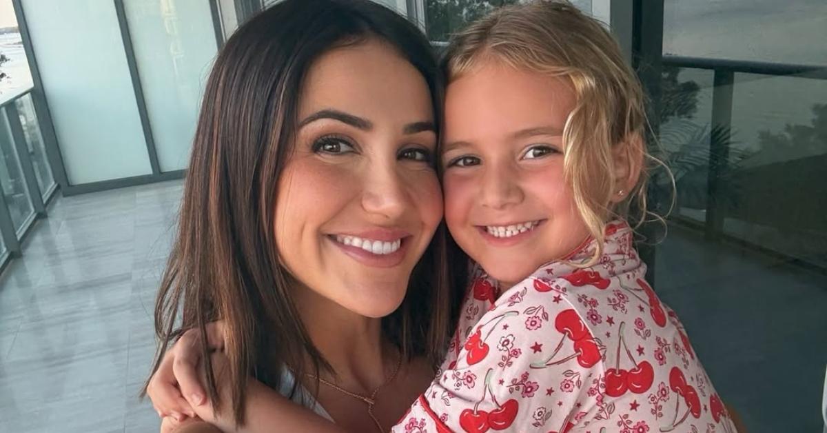 Kat Stickler and her daughter on a balcony.