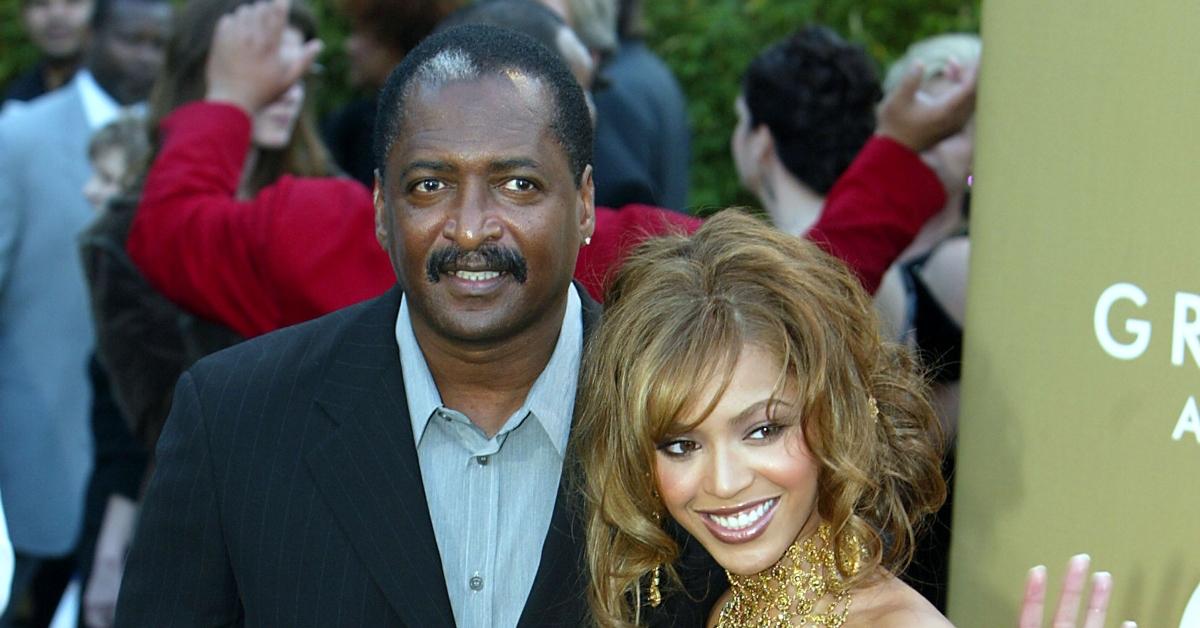 Mathew Knowles and Beyonce smile and wave at the  46th Annual Grammy Awards in 2004.