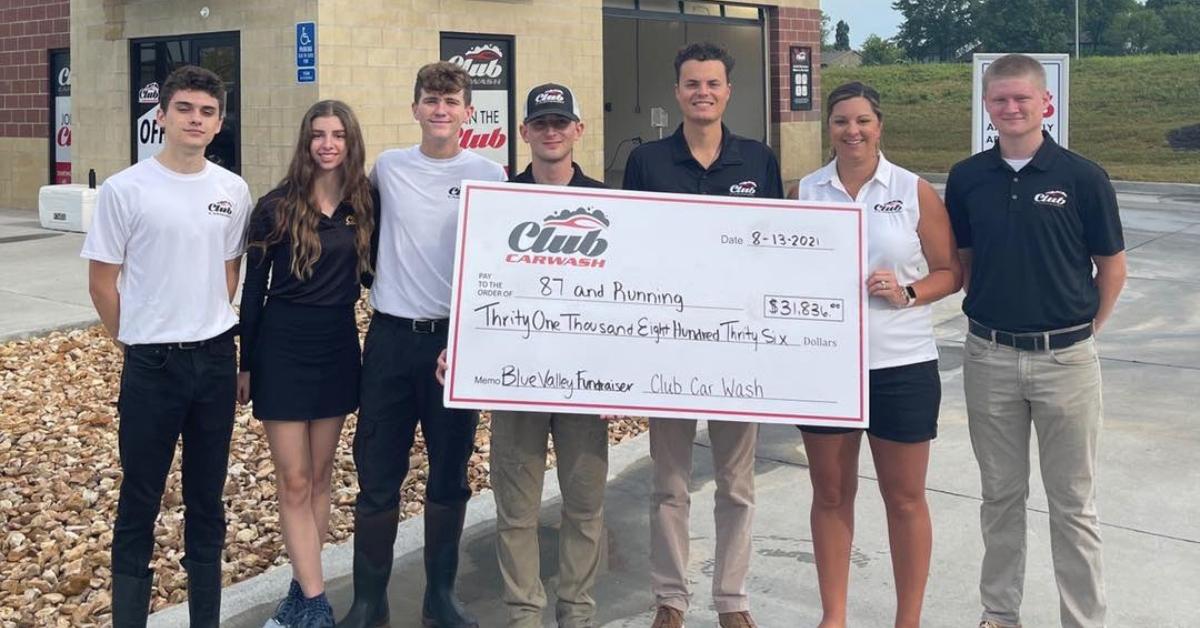 87 & Running receives a donation check.