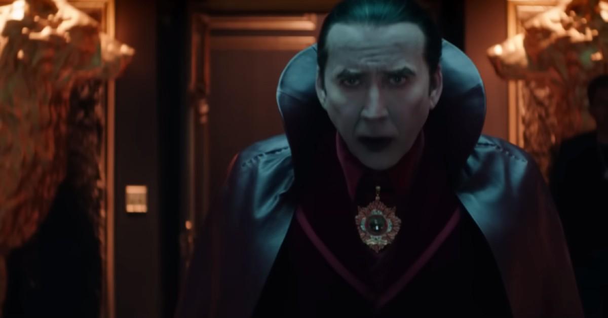 Dracula (Nicolas Cage), in a satin black cape, brooding in his castle