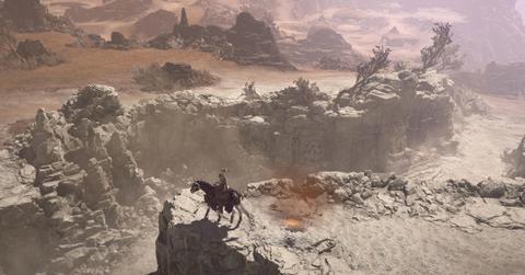 'Diablo IV' Character traveling through a rocky landscape on horseback.