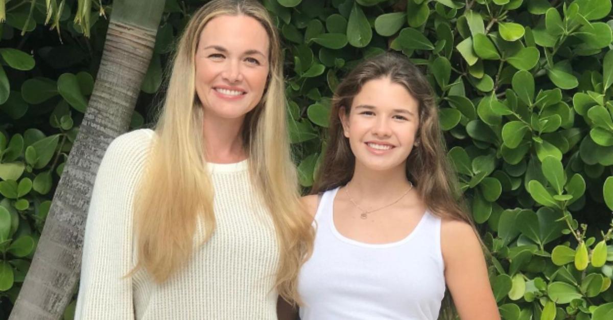 Kai Madison Trump with her mom in front of a wall of greenery