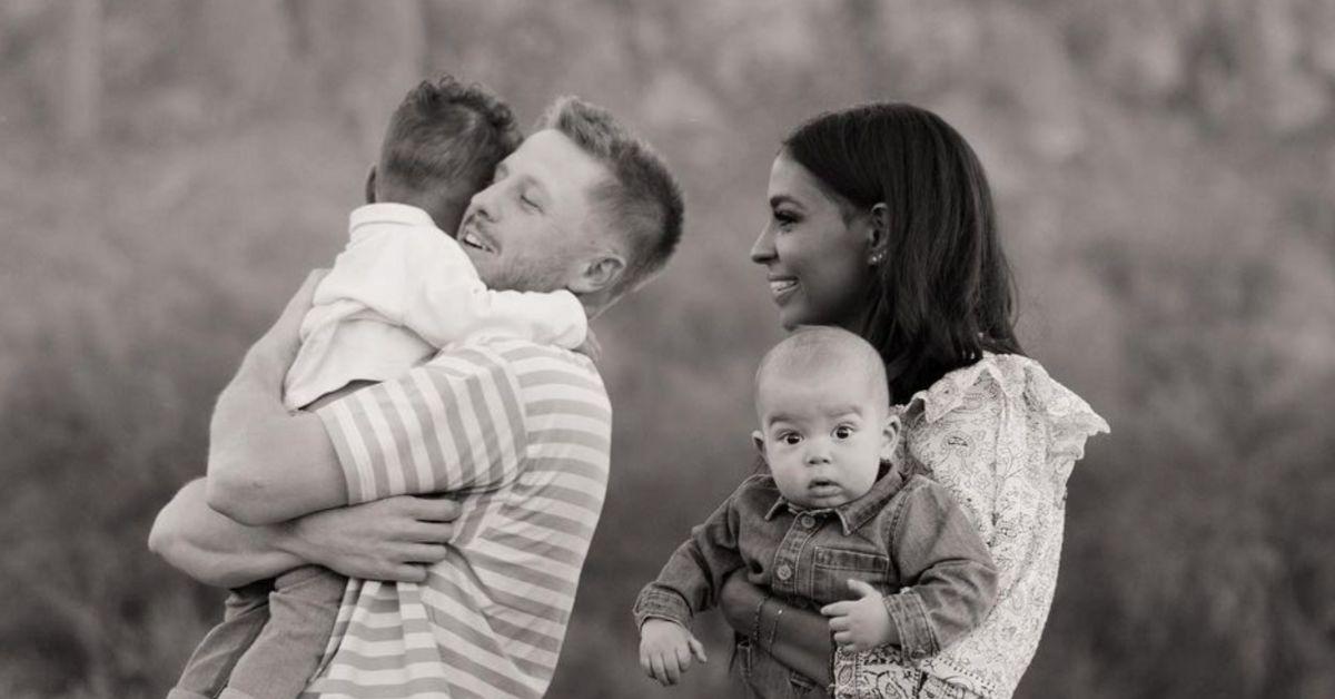 Clayton Wessel holds their eldest son while Layla Taylor looks on while holding their youngest child for a family photo.