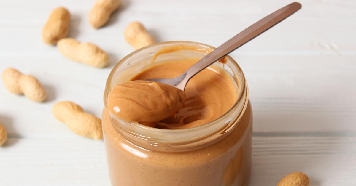 A jar full of creamy peanut butter.