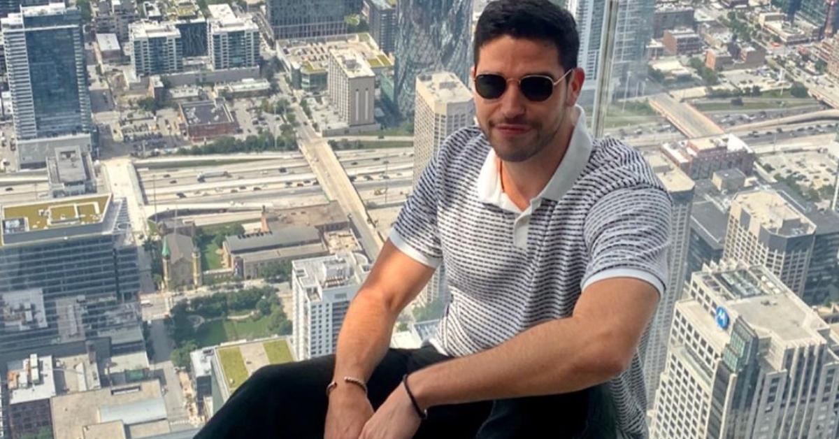 Devin Strader sits on a glass floor in a building in Chicago