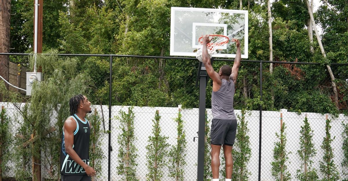 Zaire Wade and his dad Dwyane Wade play basketball in the backyard.