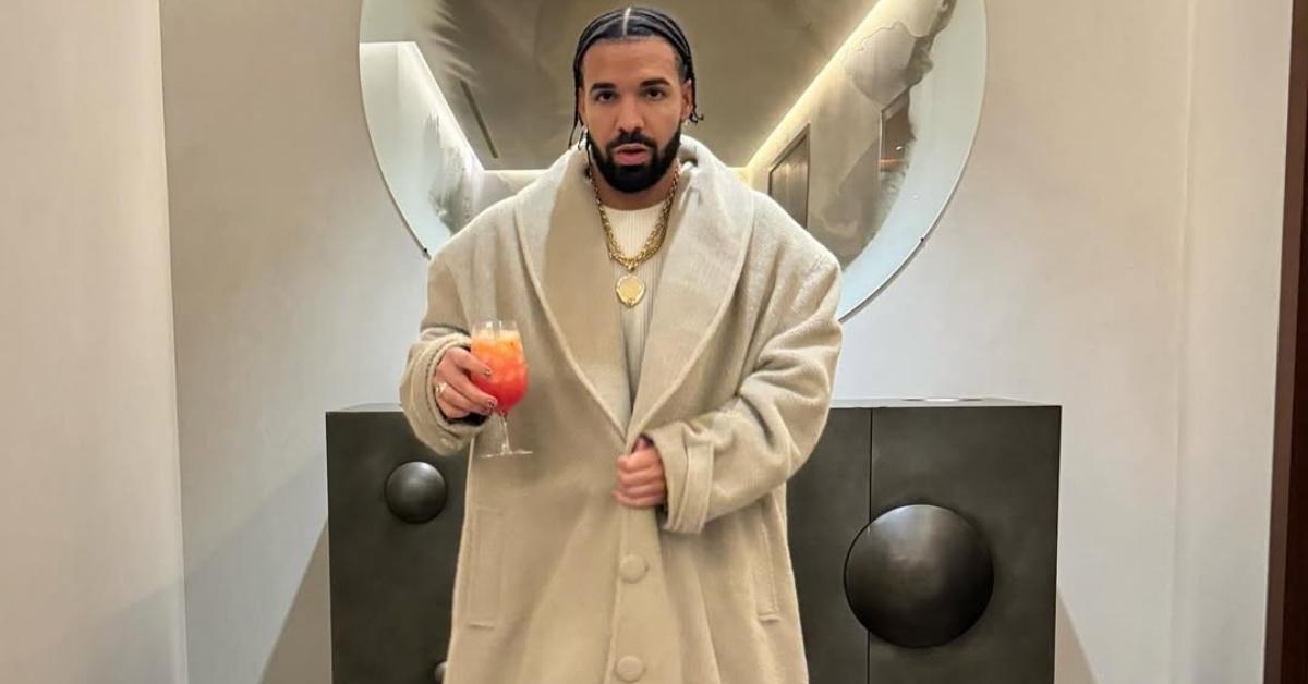 Drake in a long beige coat