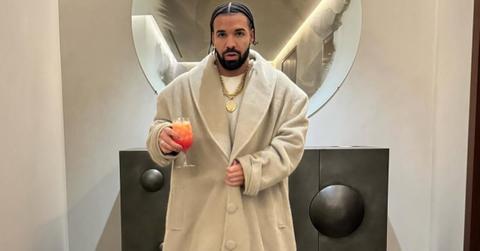 Drake in a long beige coat
