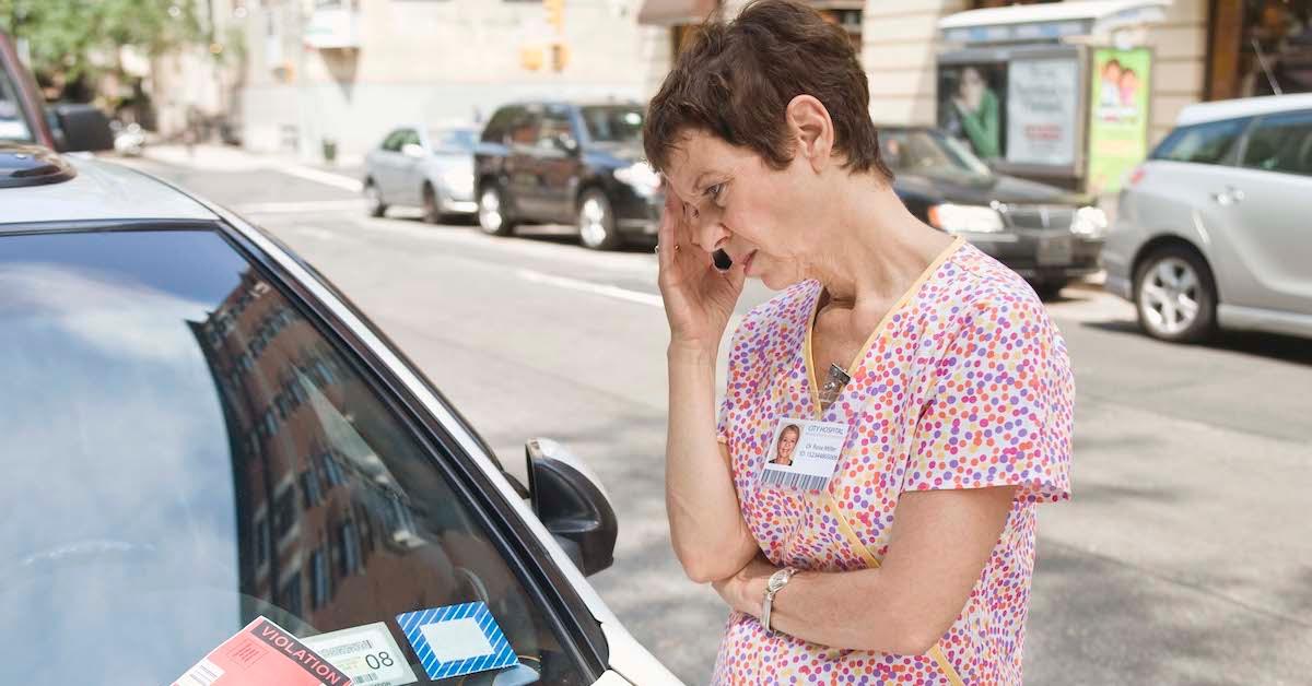 A woman staring at a parking ticket