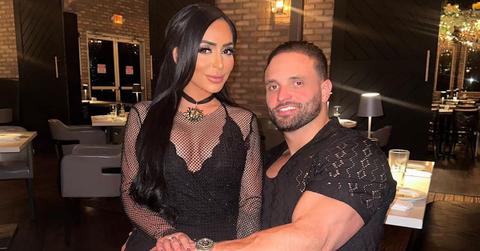 Angelina Pivarnik sitting on Vinny Tortorella's lap