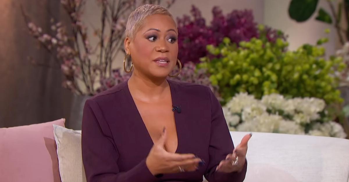 Monique Kelly wears a plum-colored v-neck long-sleeve dress while giving dating advice on 'The Jennifer Hudson Show.'