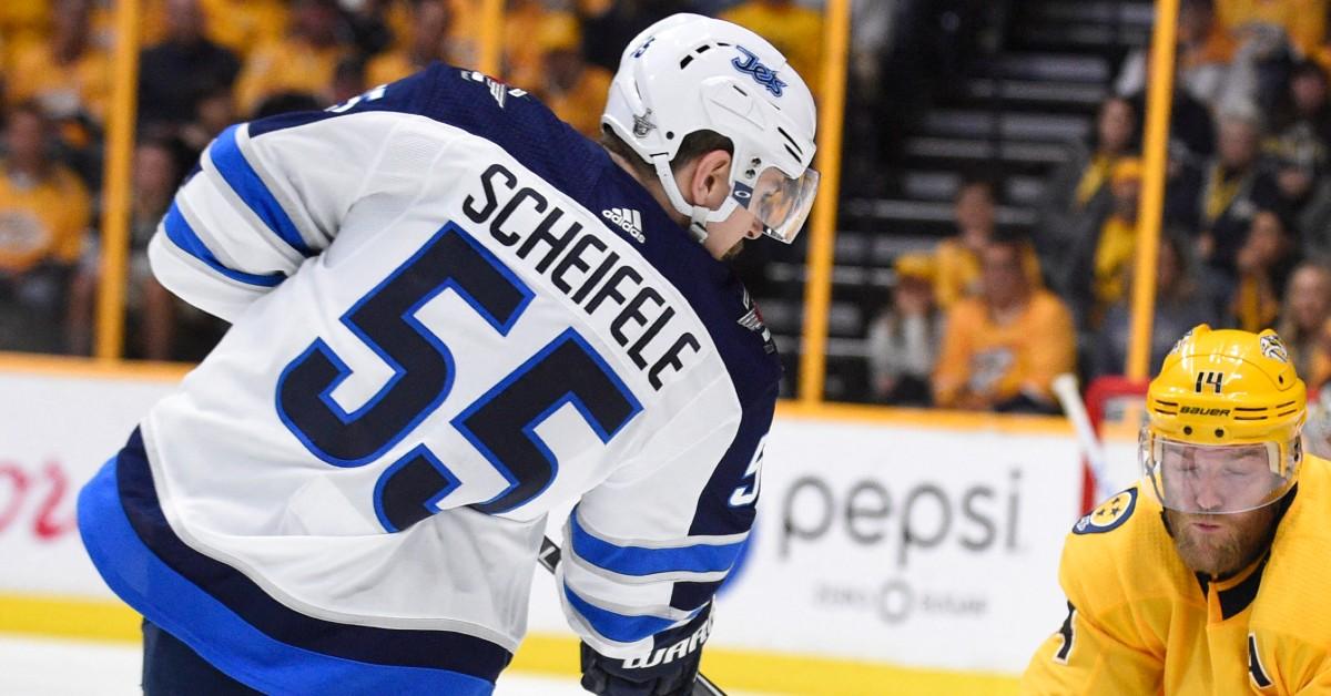 Mark Scheifele playing hockey with back to camera