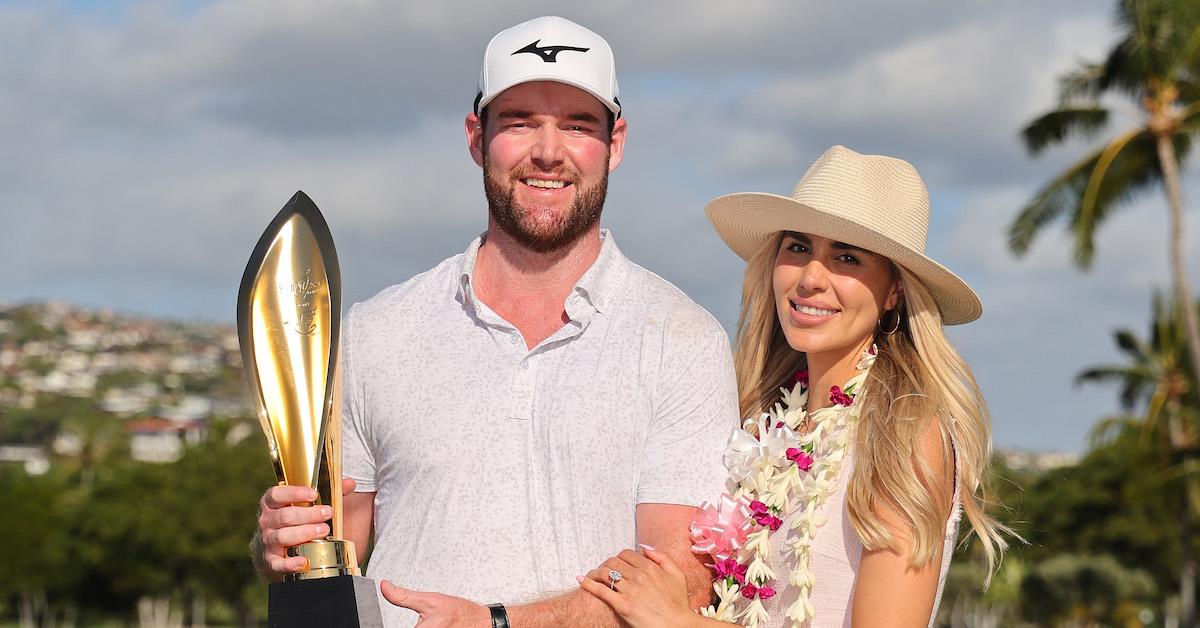 Grayson Murray and his fiancée Christiana pose with the trophy after he won the Sony Open on the first playoff hole in Hawaii at Waialae Country Club on Jan. 14, 2024 