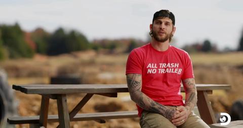 Bryce Sparks sits at a picnic table near a racing course on Mud Madness