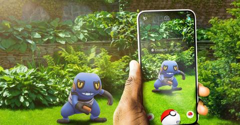 'Pokémon GO' Promo art of a Trainer battling a toad-like Pokémon.