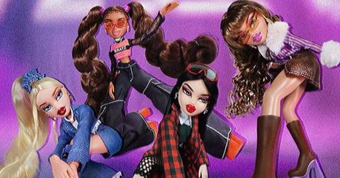 Four Bratz dolls posing in front of a purple background