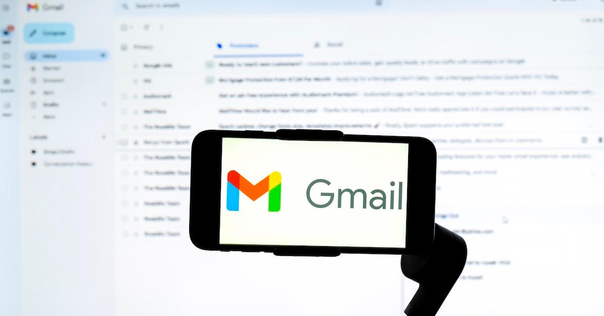 Gmail on phone in front of Gmail inbox