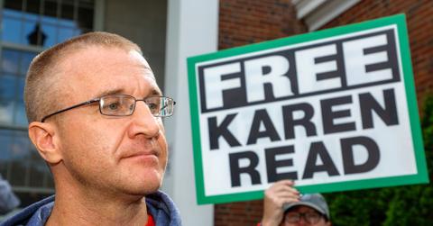 Aidan Kearney aka Turtleboy next to a sign that says "Free Karen Read"