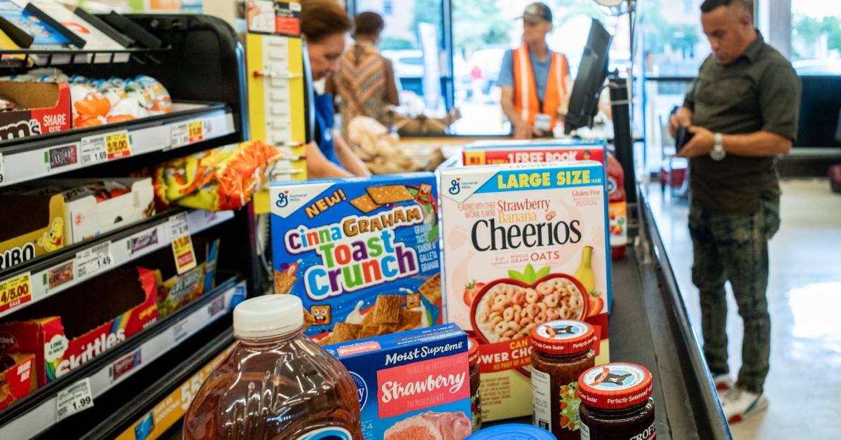 A cashier processes a customer's order in a Kroger grocery store