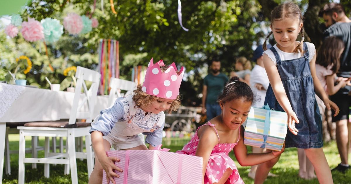 Group of small girls with presents at an outdoor birthday party