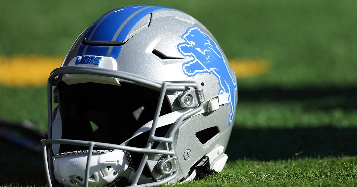 A lions helmet sitting on a field. 