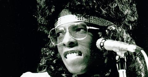 Sly Stone performing with glasses on.