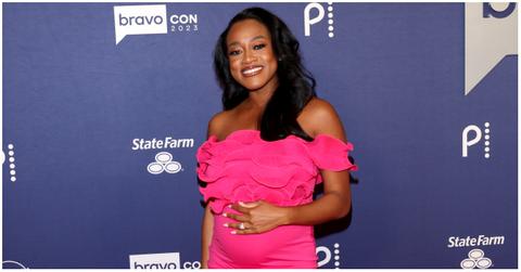 Jasmine Ellis Cooper holding her baby bump