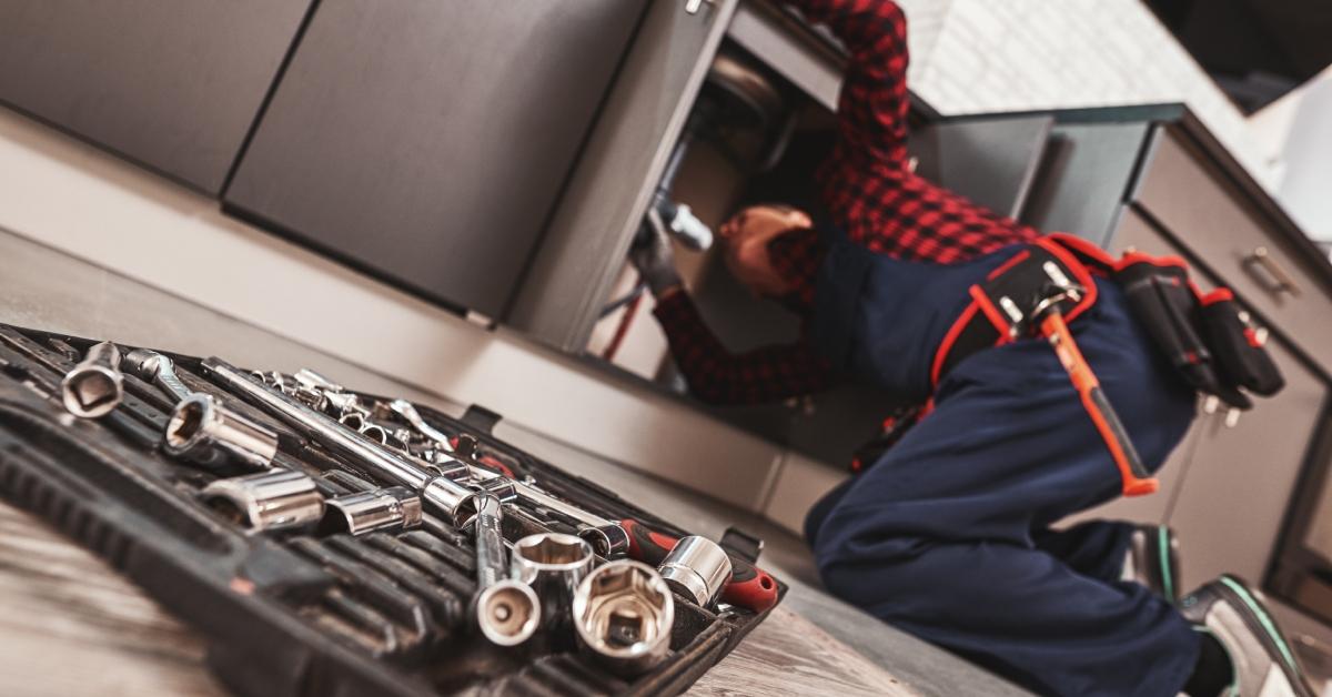 man repairing kitchen sink