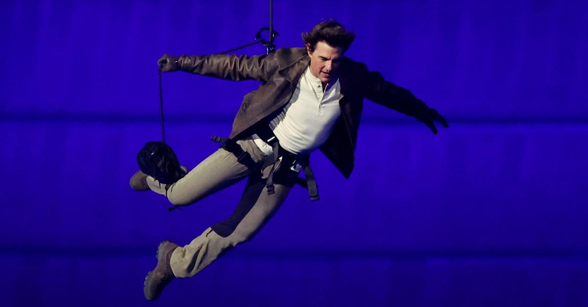 PARIS, FRANCE - AUGUST 11: Actor Tom Cruise jumps from the roof of the Stade de France during the Closing Ceremony of the Olympic Games Paris 2024 at Stade de France on August 11, 2024 in Paris, France. (Photo by Fabrizio Bensch- Pool/Getty Images)