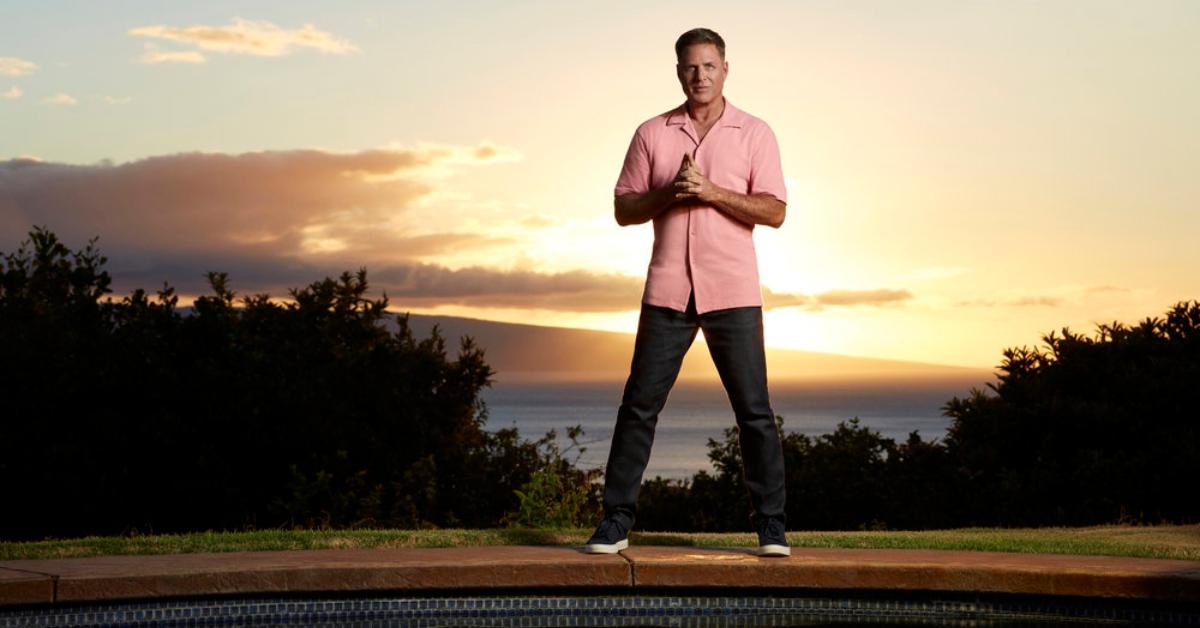 'Temptation Island' host Mark L. Walberg stands poolside